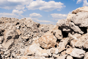 Pile of stones and blue sky with clouds.