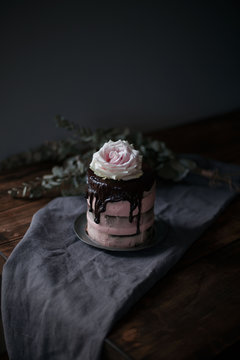 Raspberry cake served on plate on wooden table