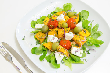 Warm salad with roasted pumpkin and cherry tomatoes with homemade cheese and olives, selective focus