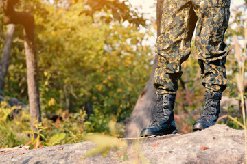 Soldier stand on the rock in nature background