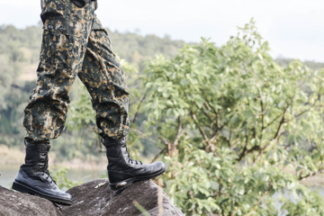 Soldier stand on the rock in nature background