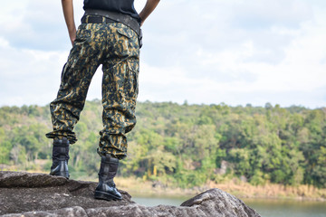 Soldier stand on the rock in nature background 