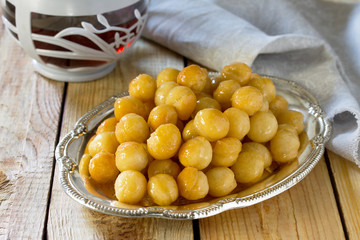 Loukoumades donuts with honey and cinnamon. The concept of celeb