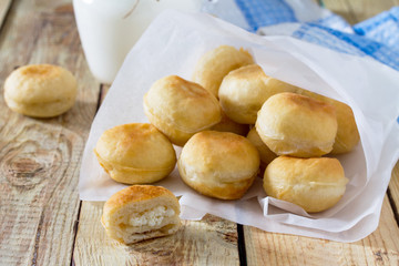 Doughnuts with filling sweet cottage cheese on a wooden backgrou