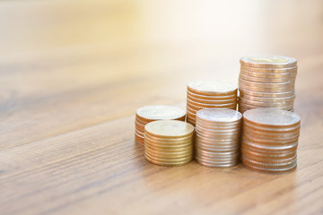 Hand holding coin on old wood tree bokeh background.concept save money
