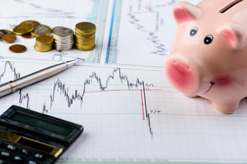 calculator and piggy bank, dynamics of exchange. Financial savin