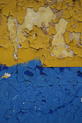 Old wall painted yellow and blue