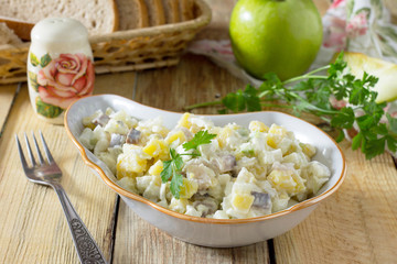 Salad with herring, eggs, apples and potatoes. Snack on a festiv
