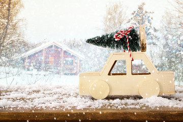 Wooden car carrying a christmas tree