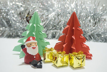 Santa   sitting in front of red and green Christmas tree waiting for Christmas