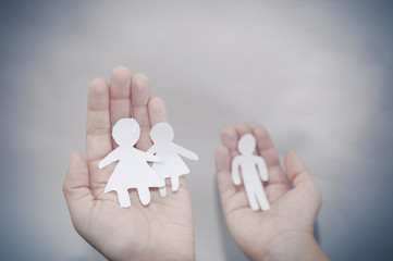 Paper Family in Hands over sea on Sunny Background. Family and Kids Concept