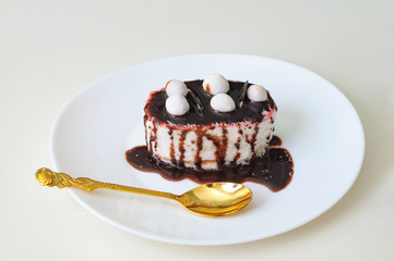 Coffee cake with coconut and chocolate on white plate