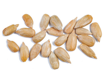 peeled sunflower seeds on white surface.
