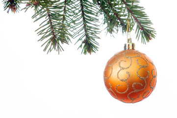 A orange Christmas bauble hanging from a branch of a Christmas 