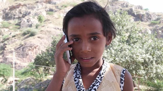 Lovely little Indian talking on her cell phone mobile 