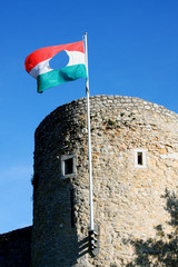 Old one Barbican bastion of Pecs in Hungary with national flag.
