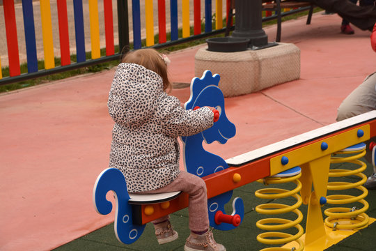 ni&ntilde;a jugando sobre un columpio