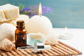 Bathroom SPA set with essential oil, salt, bomb, nadmade soap and lit candles. Concept for massage, relaxation and aromatherapy