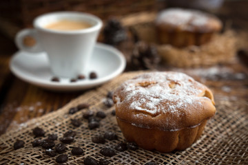 Breakfast with pastries and coffee in the rustic style on old boards