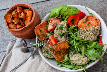 Arugula, vegan lentil fried cutlets, baked sweet potato, tomato, avocado, pepper.  Perfect for the detox diet or just a healthy meal.  Love for a healthy raw food concept.