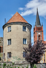 Turret and church tower with a clock in Niemcza.