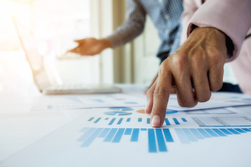 Business concept. Business people discussing the charts and graphs showing the results of their successful teamwork.