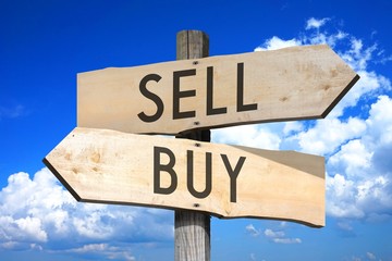 Sell, buy - wooden signpost