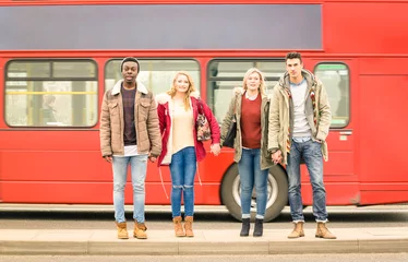 Foto op Plexiglas Multiracial friends group crossing road ahead, traditional red bus, Autumn or winter, concept of social life with young people hanging out together © Mirko Vitali