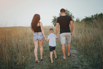 Fototapeta premium young family with a child have fun outdoors