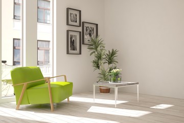 White room with green armchair and urban landscape in window. Scandinavian interior design