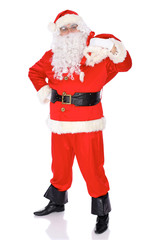 Santa Claus standing with his sack full of presents, isolated on white background. Full length portrait