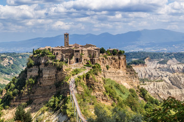 Civita di Bagnoregio, Italy. A scenic view of the town on a background of mountains