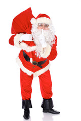 Santa Claus standing with his sack full of presents, isolated on white background. Full length portrait