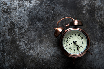 Alarm clock on dark background. top view

