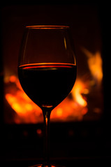 Wineglass by a cozy fire