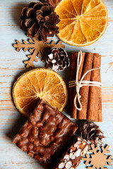 Christmas sweets, cinnamon, orange slices and pine cones