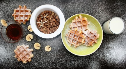 Breakfast table. Belgium waffles with a glass of milk and honey.