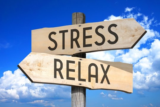 Stress, relax - wooden signpost