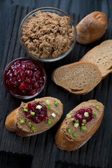 Sliced baguette with liver pate and cranberry sauce, studio shot