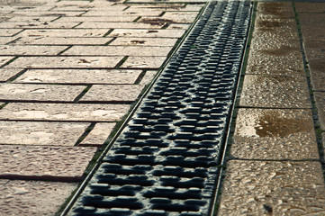 Fototapeta premium The drainage on the sidewalk.