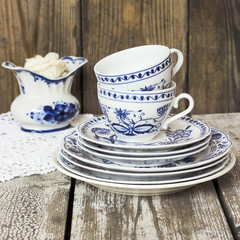 Clean dishes - cups and plates - on a wooden table