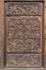 Old wooden door with carved patterns. Architecture