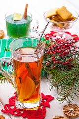 Winter hot drink with spices on wooden table.