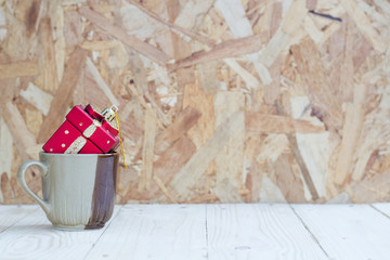 Gift box on Cup with wooden background