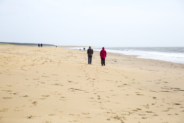 Fototapeta na wymiar People walking on the beach, L'aiguillon sur Mer, Vendree, France