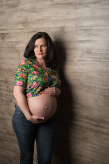 Pregnant girl against the wall