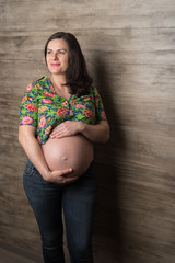 Pregnant girl against the wall