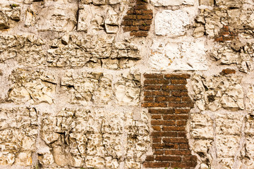 pattern gray color of modern style design decorative uneven cracked real stone wall surface with cement.