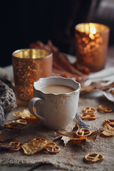 Autumn leaves, hot steaming cup of coffee and a warm scarf