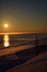 Sunset on a background of frozen sea
